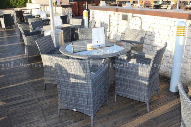 Smart Choice – Affordable Strength in Every Strand Gradient-toned woven rattan table and chairs on an outdoor deck, offering affordable yet long-lasting commercial-grade outdoor seating