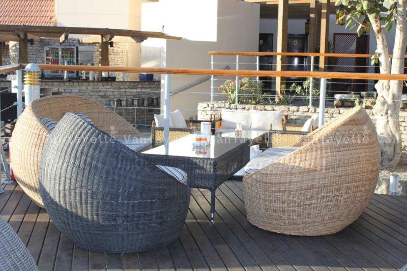 Woven Precision – Where Form Reflects Mastery A semi-circular rattan sofa and matching coffee table crafted with fine round weaving, highlighting CG’s craftsmanship and material excellence