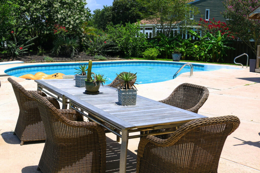 Handwoven rattan armchairs paired with aluminum table, showcasing CG Outdoor’s refined craftsmanship and modern design