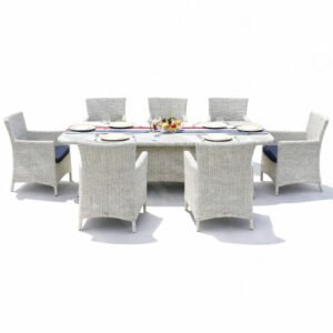 Outdoor wicker dining set with aluminum frame and glass tabletop, featuring six woven armchairs arranged around a rectangular table.