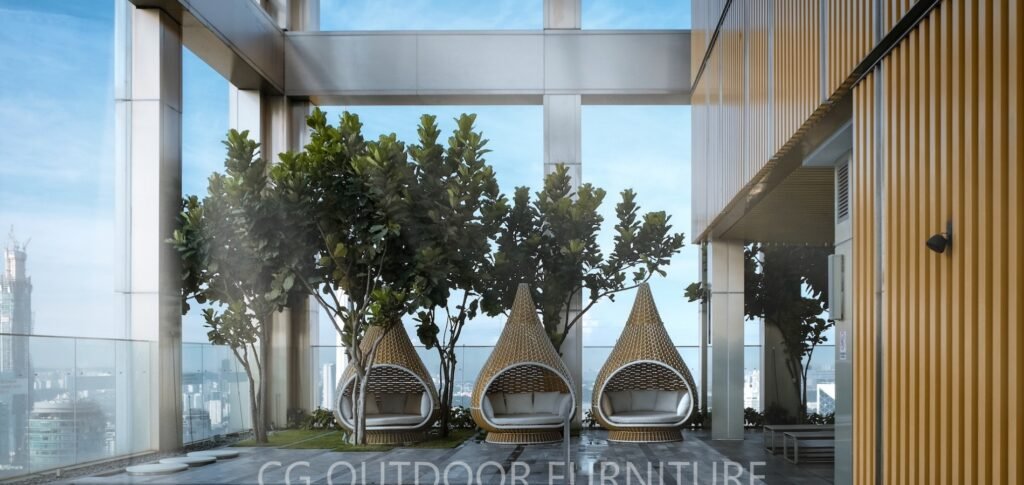 A thick-woven, swivel white lounger placed in a luxury hotel garden space — elegant, modern, and custom-designed by CG