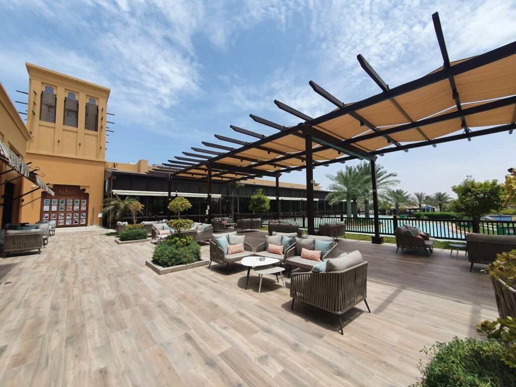 Commercial outdoor lounge furniture arranged in a hotel resort courtyard, demonstrating stable seating systems designed for high-traffic hospitality environments and long-term daily use.