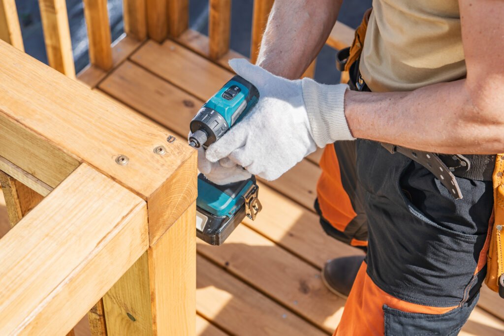 Precision Craftsmanship in Outdoor Furniture Manufacturing Professional worker assembling premium outdoor wooden furniture using precision tools, highlighting craftsmanship, quality control, and durable outdoor furniture construction.